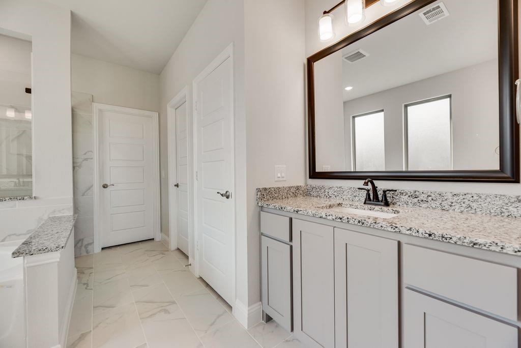 597 MB's Way Pilot Point, TX 76258 - Photo 27 of 34 a bathroom with a granite countertop sink and a mirror