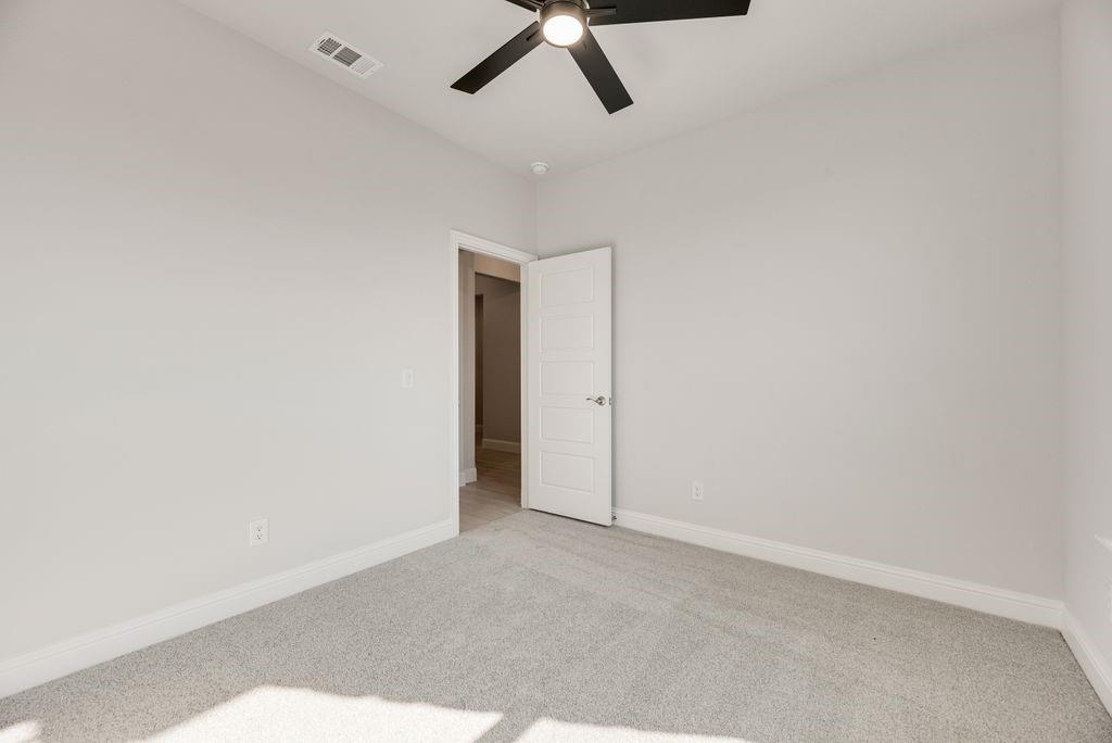 597 MB's Way Pilot Point, TX 76258 - Photo 28 of 34 an empty room with a ceiling fan and carpet