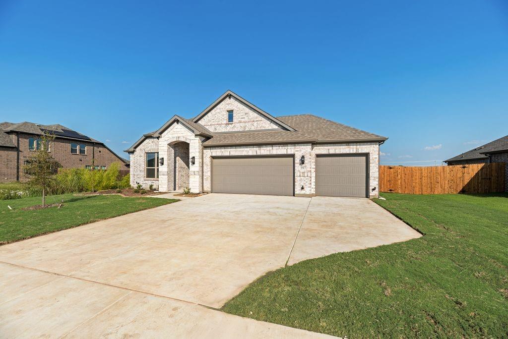 597 MB's Way Pilot Point, TX 76258 - Photo 4 of 34 a front view of a house with a yard and garage