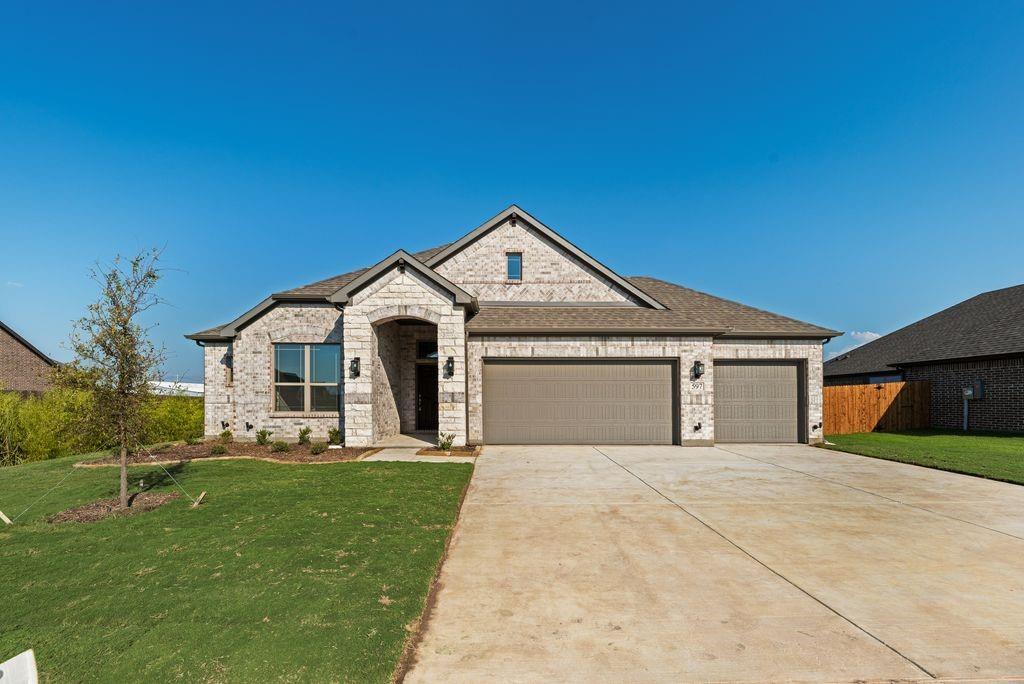 597 MB's Way Pilot Point, TX 76258 - Photo 5 of 34 a front view of a house with a yard and trees