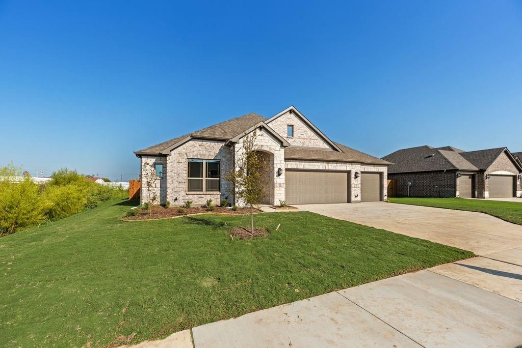 597 MB's Way Pilot Point, TX 76258 - Photo 7 of 34 a front view of a house with a garden