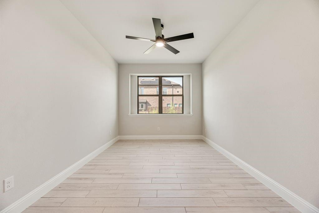 597 MB's Way Pilot Point, TX 76258 - Photo 10 of 34 an empty room with wooden floor ceiling fan and windows