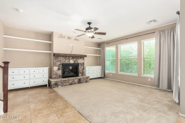 a view of an empty room with a fireplace and a window
