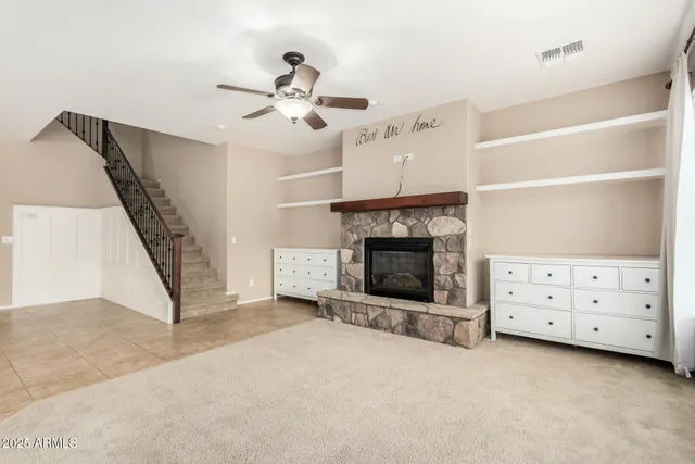 a view of an empty room with a fireplace and a window