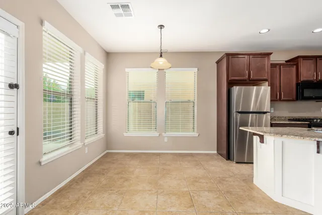 a kitchen with stainless steel appliances granite countertop a refrigerator oven a sink and a granite counter tops