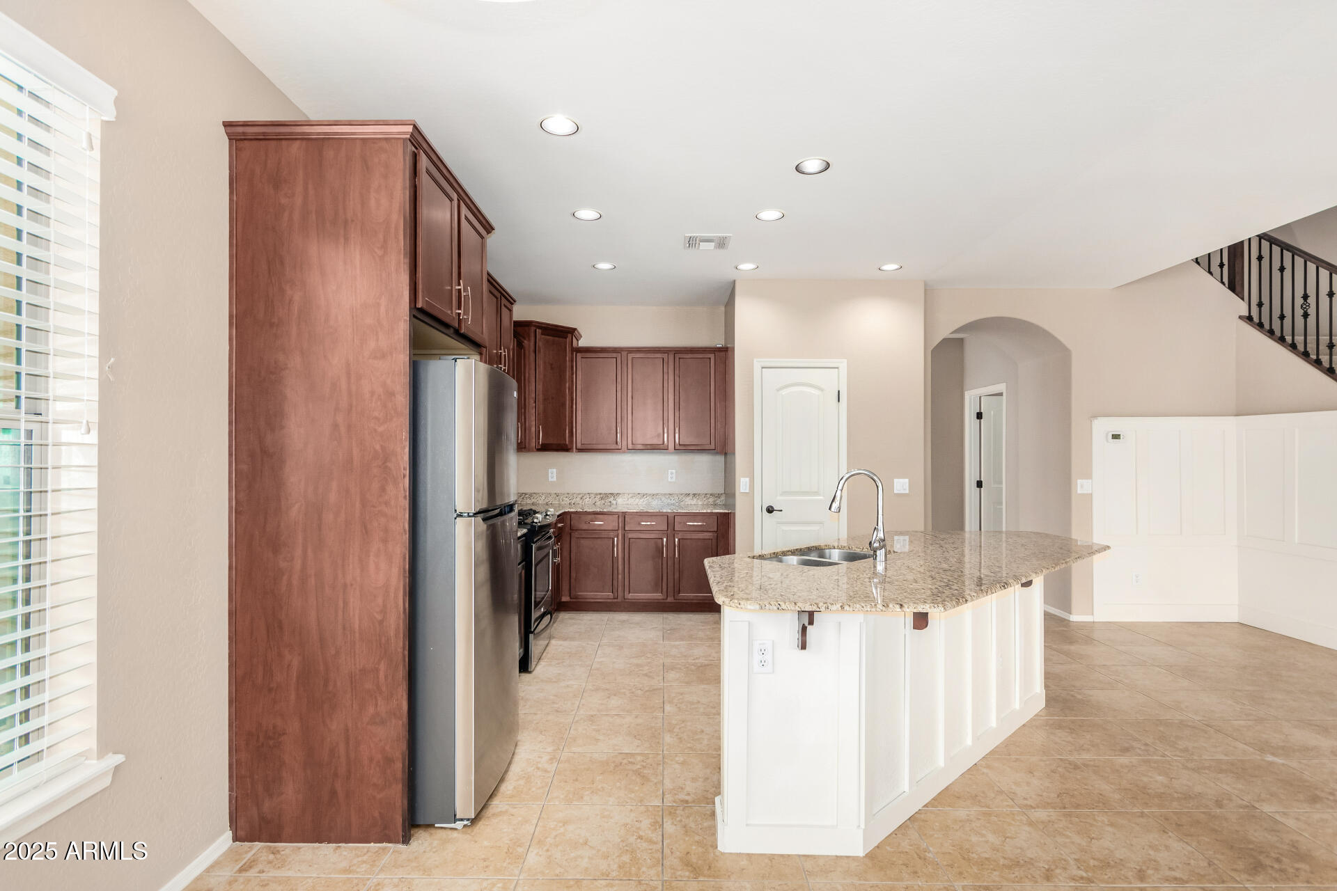 3540 East Mesquite Street Gilbert, AZ 85296 - Photo 22 of 55 a view of kitchen with kitchen island stainless steel appliances counter space and living room