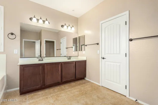 a spacious bathroom with a mirror sink and vanity