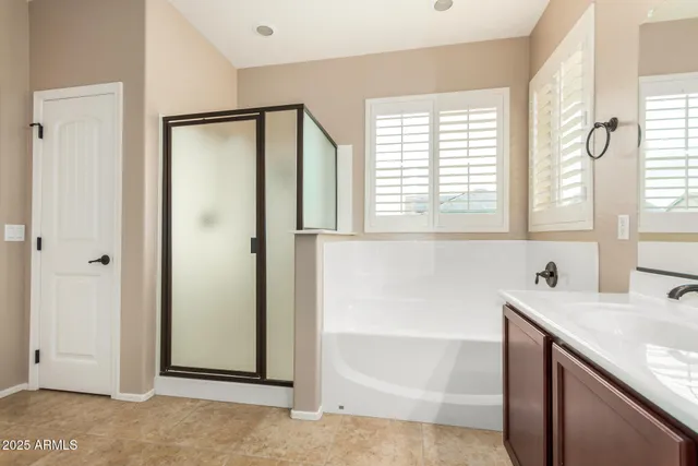 a bathroom with a tub sink and a mirror