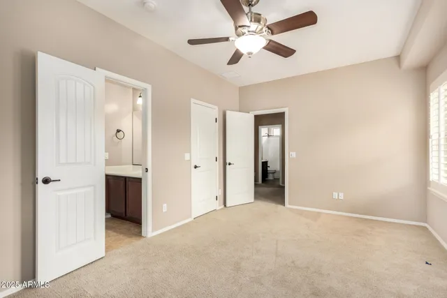 an empty room with fan and entrance