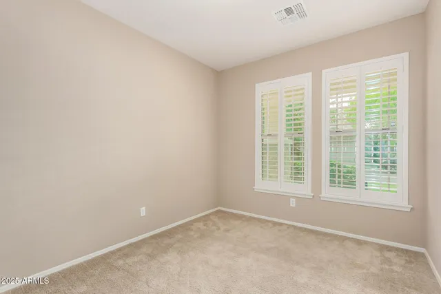 a view of an empty room with glass door