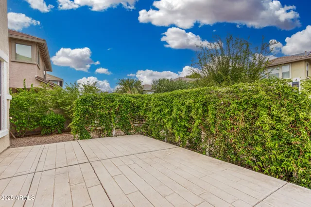a view of a backyard of the house with flower pots