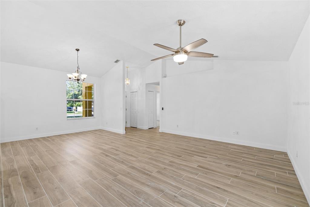 26 Marjorie Trail Ormond Beach, FL 32174 - Photo 12 of 30 an empty room with wooden floor ceiling fan and window