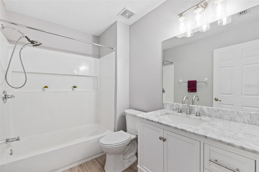 26 Marjorie Trail Ormond Beach, FL 32174 - Photo 16 of 30 a bathroom with a granite countertop sink a toilet and shower