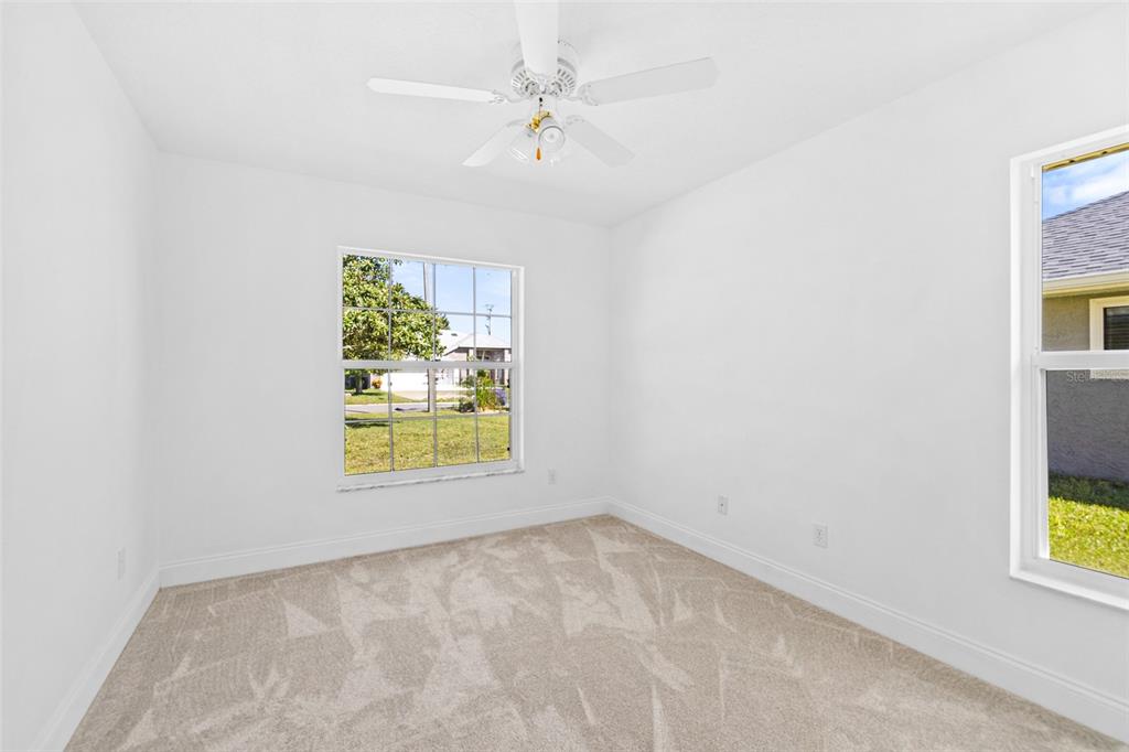 26 Marjorie Trail Ormond Beach, FL 32174 - Photo 21 of 30 an empty room with windows and chandelier fan