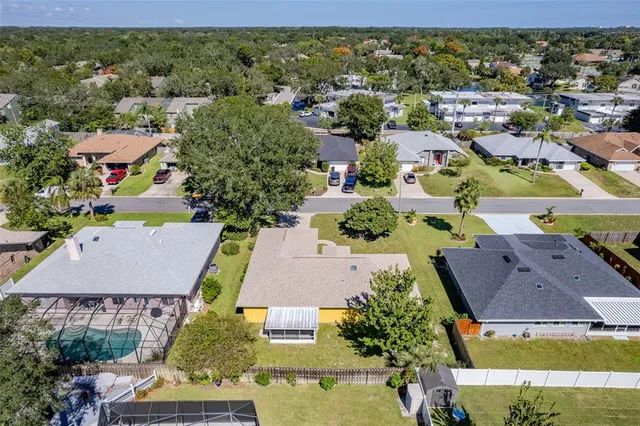 an aerial view of residential houses with outdoor space and street view