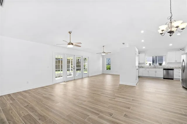 a view of a kitchen with a dishwasher cabinets and wooden floor