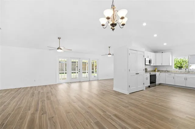 a view of a kitchen with a dishwasher kitchen stove cabinets and wooden floor