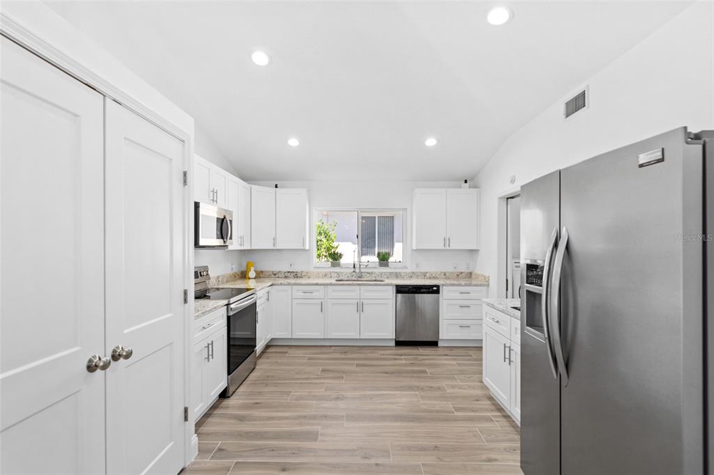 26 Marjorie Trail Ormond Beach, FL 32174 - Photo 8 of 30 a kitchen with stainless steel appliances granite countertop a refrigerator sink and stove