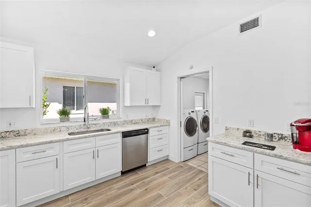 a kitchen with a sink stove and cabinets