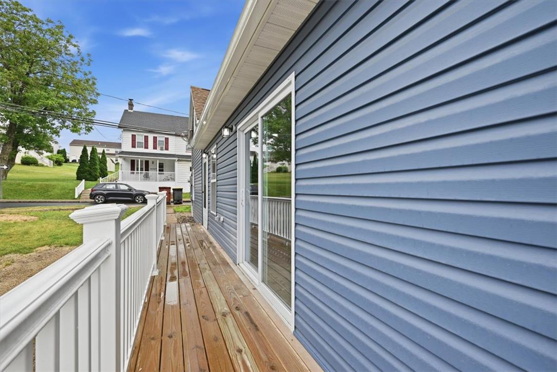 5641 North Coplay Road Whitehall, PA 18052 - Photo 52 of 68 A spacious wooden deck provides ample outdoor living space alongside durable siding.