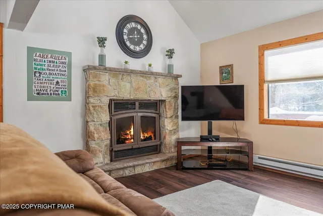 a living room with furniture a clock and a fireplace