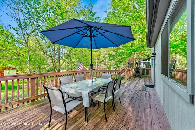 a view of balcony with chairs and wooden floor