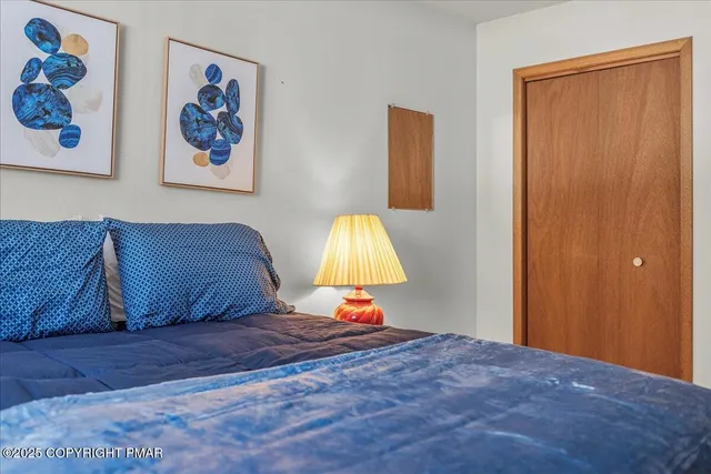 a bedroom with a large bed and a window