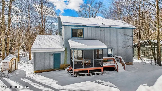a view of a patio with table and chairs with wooden floor and fence