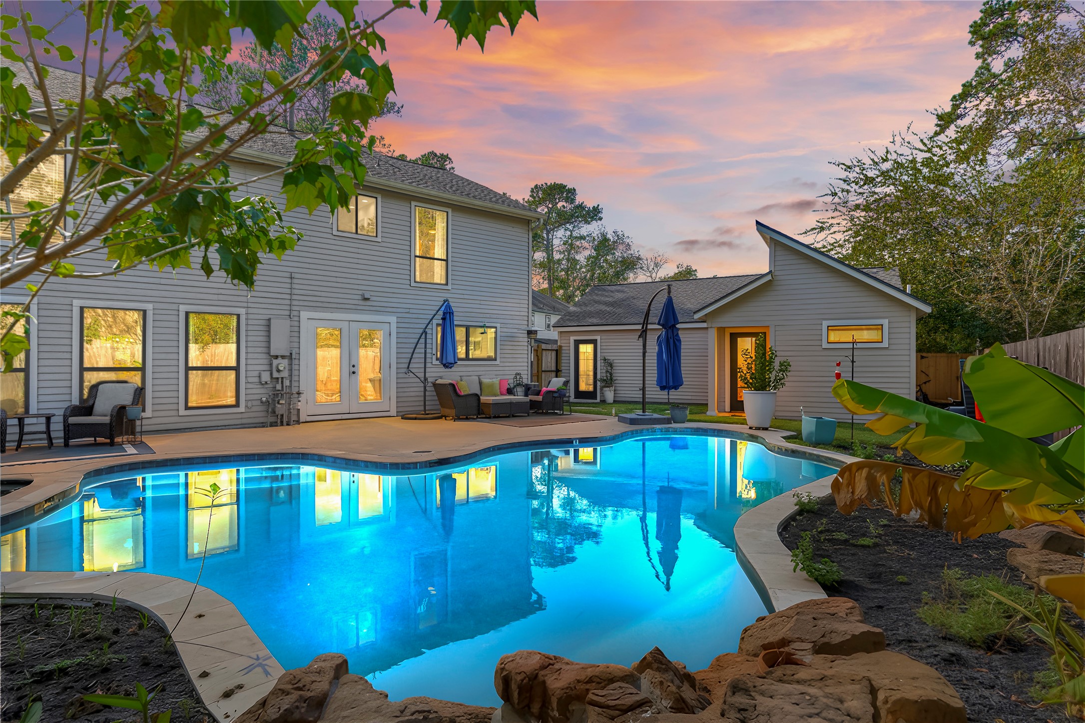 a front view of a house with swimming pool having outdoor seating