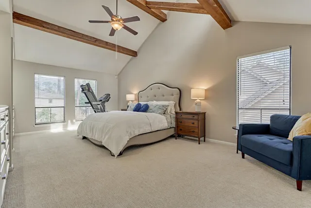 a bedroom with a bed and a mirror on dresser