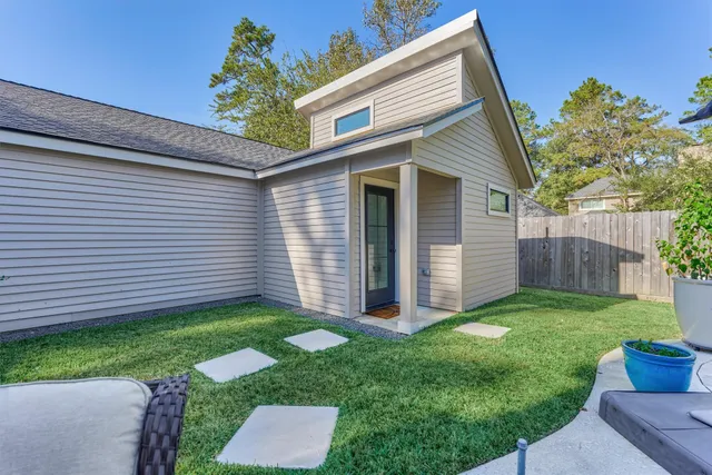 a view of a hallway with wooden floor and furniture