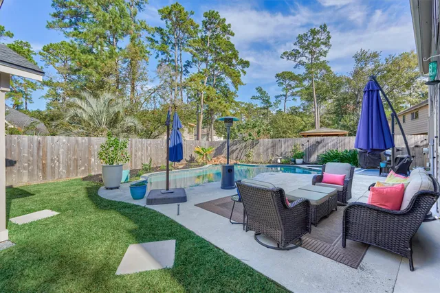 a backyard of a house with table and chairs