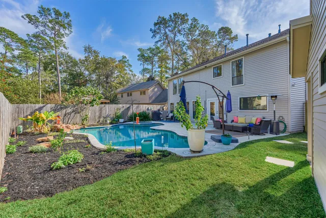 a view of a house with pool and chairs
