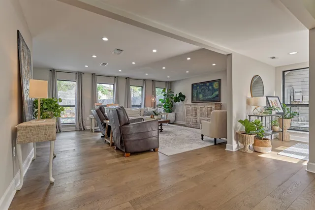 a living room with furniture and potted plants