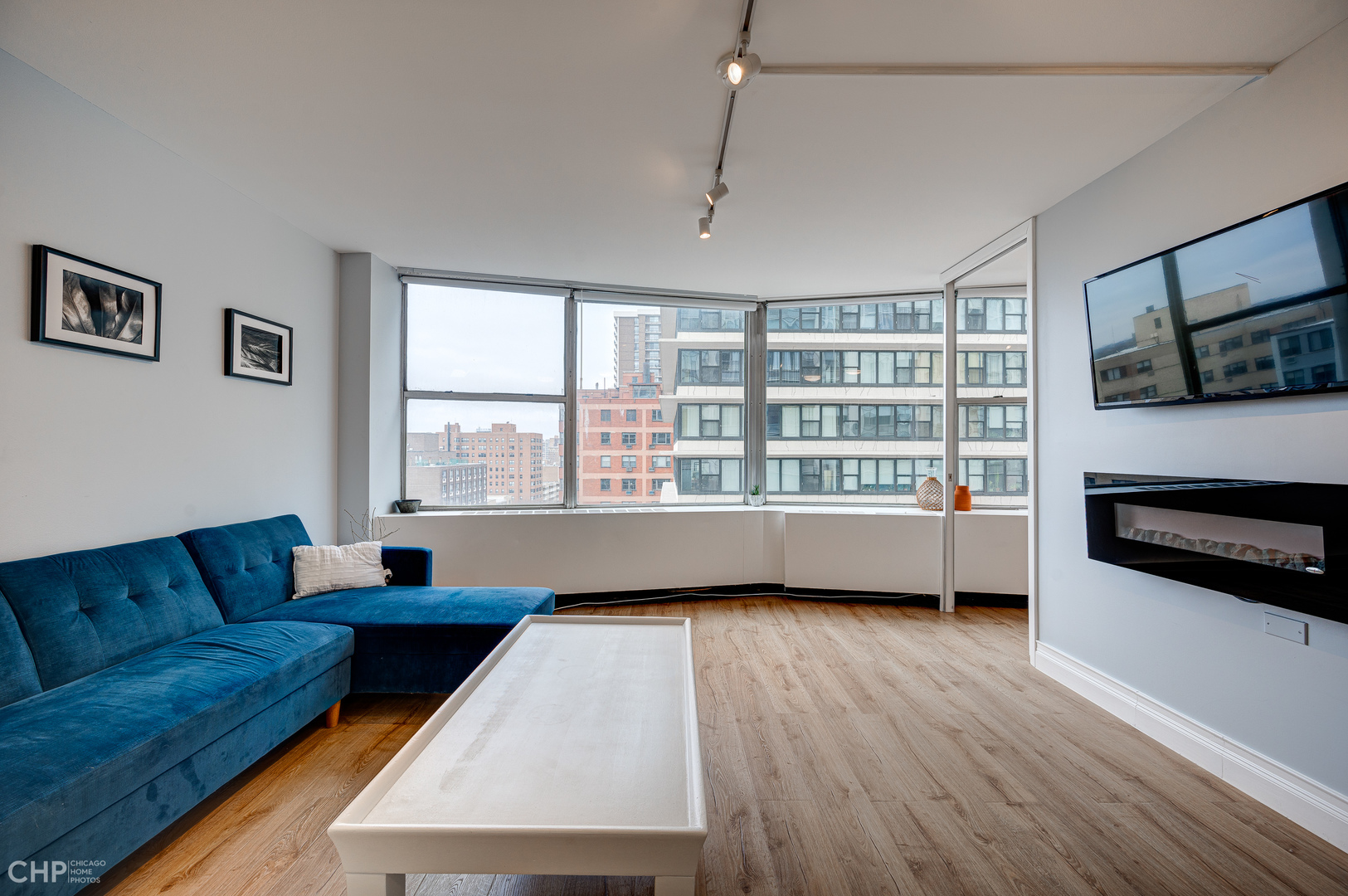 5757 North Sheridan Road, Unit 10G Chicago, IL 60660 - Photo 2 of 11 a living room with furniture and a flat screen tv