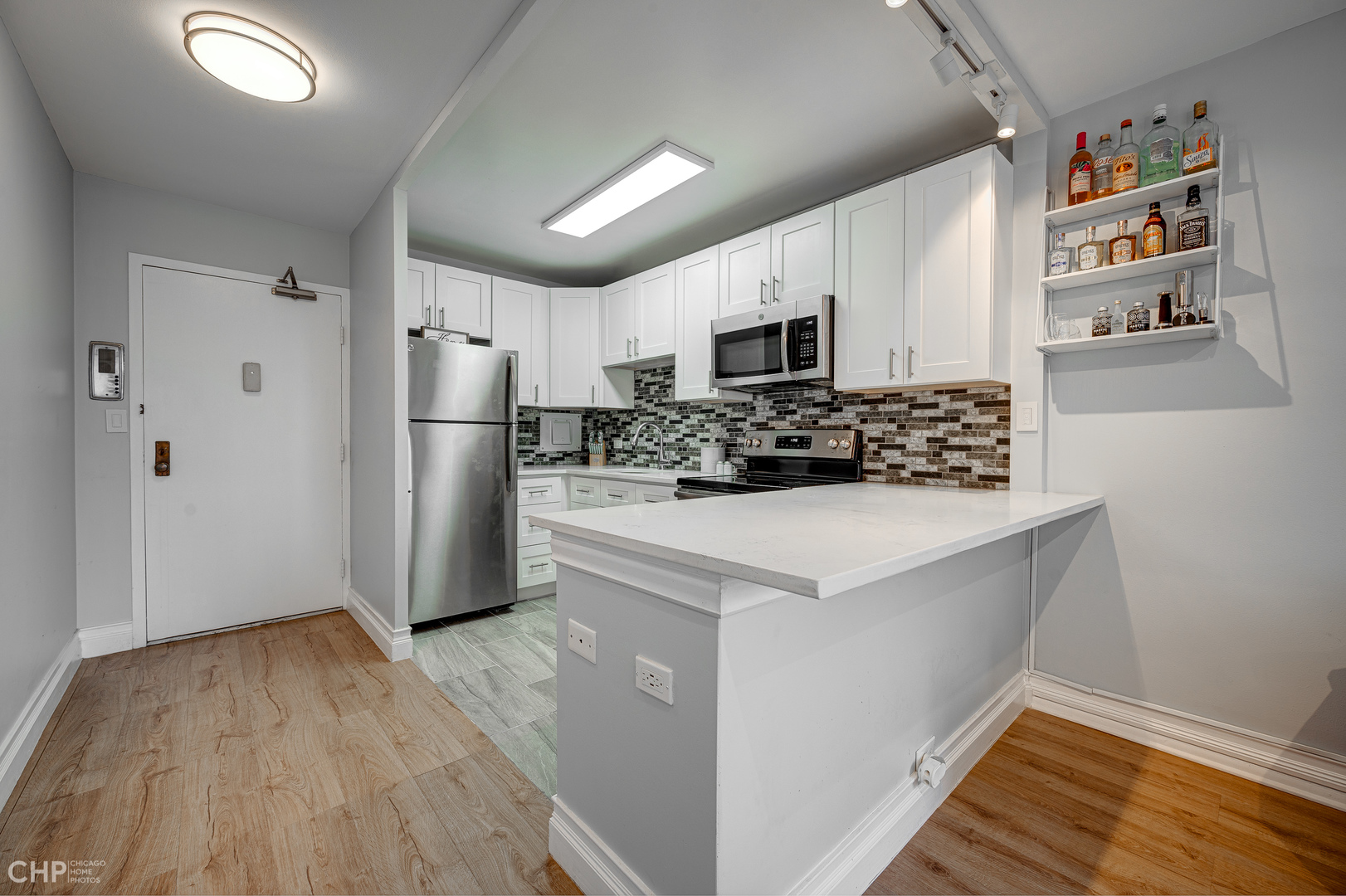 5757 North Sheridan Road, Unit 10G Chicago, IL 60660 - Photo 4 of 11 a kitchen with stainless steel appliances a refrigerator stove microwave and sink
