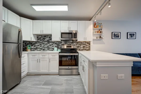 a kitchen with a white stove top oven and refrigerator