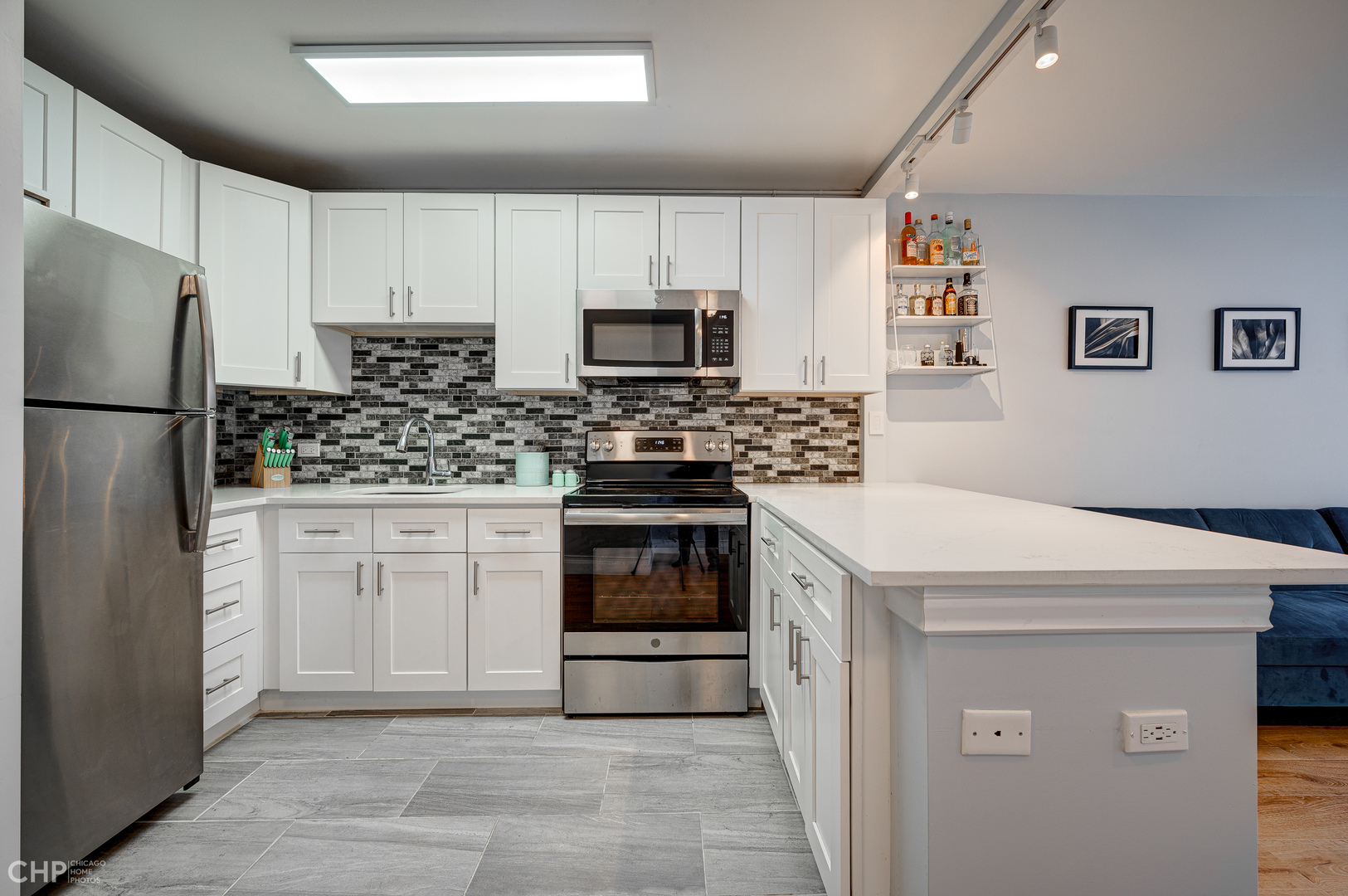 5757 North Sheridan Road, Unit 10G Chicago, IL 60660 - Photo 5 of 11 a kitchen with a white stove top oven and refrigerator