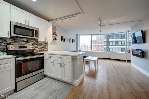a kitchen with a stove a sink and a microwave