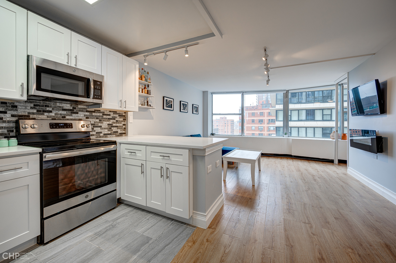 5757 North Sheridan Road, Unit 10G Chicago, IL 60660 - Photo 6 of 11 a kitchen with a stove a sink and a microwave