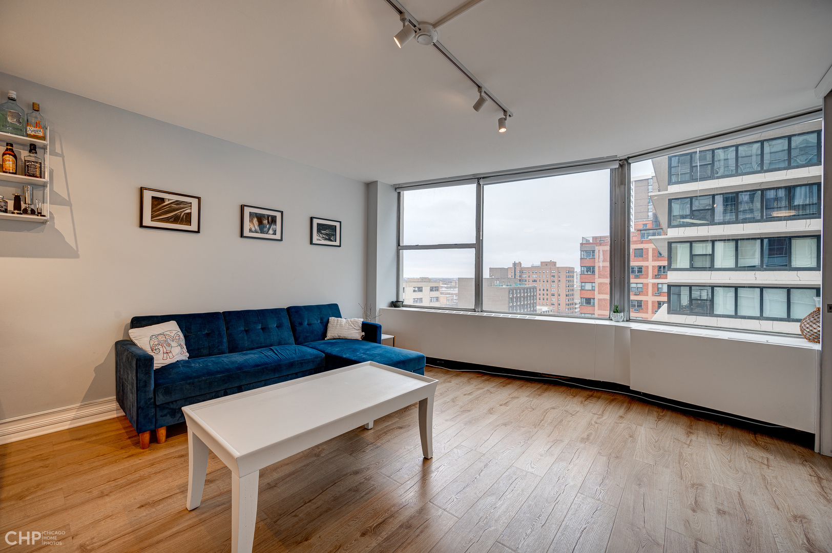 5757 North Sheridan Road, Unit 10G Chicago, IL 60660 - Photo 8 of 11 a living room with furniture and a window