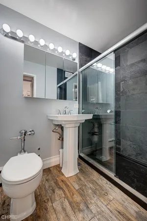 a bathroom with a sink toilet and shower