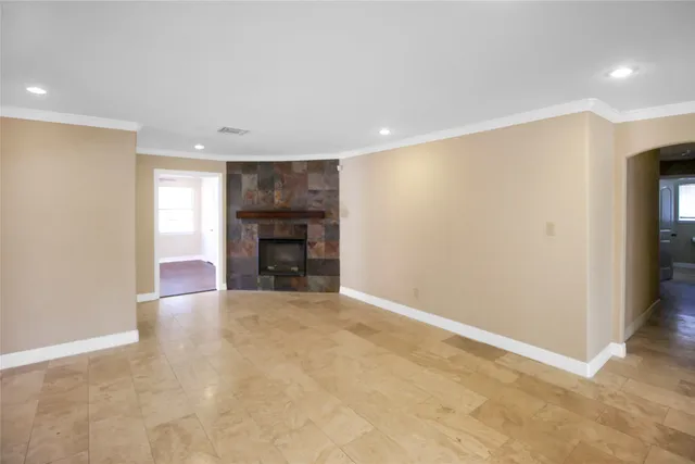 a view of an empty room with a fireplace