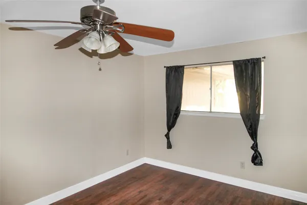 a view of a workspace with a window and a chandelier fan
