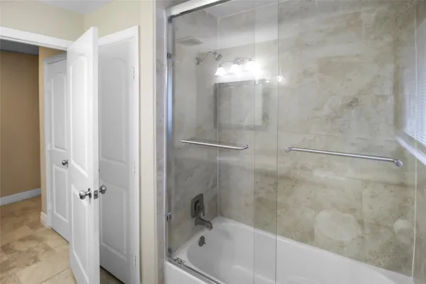 a bathroom with a bathtub and a shower
