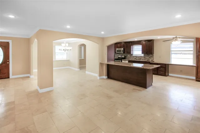 a large kitchen with stainless steel appliances granite countertop a stove and a sink