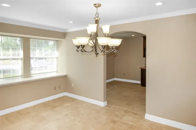a view of a chandelier in a room with a window