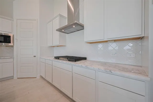 a kitchen with granite countertop cabinets stainless steel appliances and a counter top space