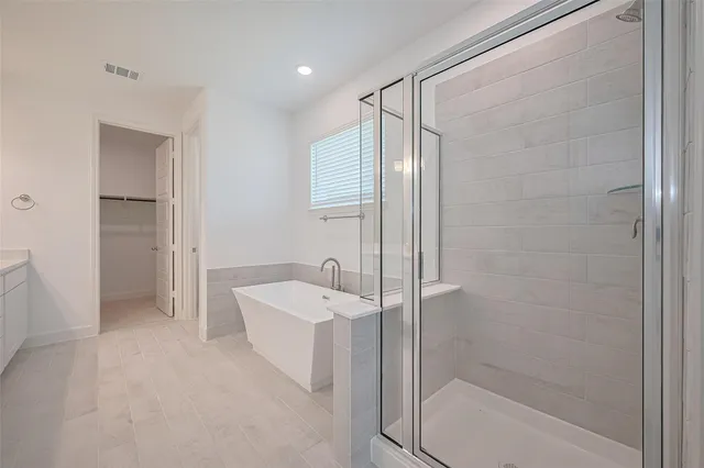 a en suite bathroom with a shower a sink and a mirror