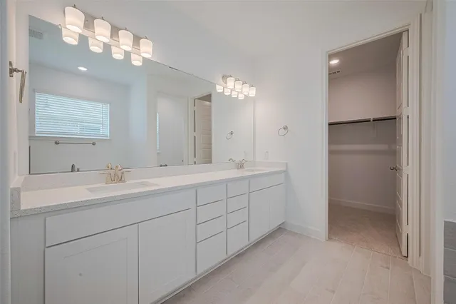 a bathroom with double sink and a mirror